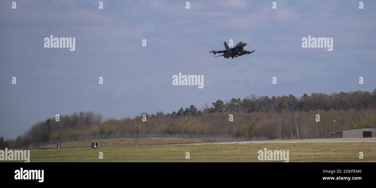 An F-16 Fighting Falcon assigned to the 52nd Fighter Wing takes off from the runway as part of exercise Point Blank 21-02 at Spangdahlem Air Base, Germany, April 9, 2021. Aircraft from Spangdahlem took part in a multi-day exercise over the North Sea alongside Royal Air Force Lakenheath, England, RAF Mildenhall, Engalnd, Aviano AB, Italy, and the Royal Netherlands Air Force. Stock Photo