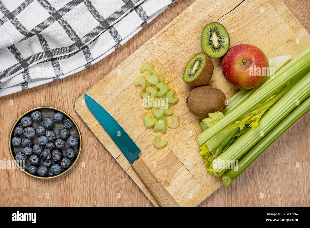 top view picture of fruits and vegetables to make detox juice with knife and kitchen towel Stock Photo