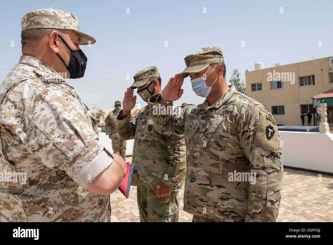 The Jordanian Armed Forces, Southern Command, 3rd Border Guard Group Commander, Col. Ra'ad Al Aamayra, and Task Force Spartan Division Tactical- Jordan Officer in Charge, Col. Christopher Fletcher, receive their country flag before they exchange flags in a symbolic gesture of friendship and partnership following the successful completion of the Desert Warrior 21 live-fire exercise, April 8, 2021. The exercise was viewed by JAF General Officers and senior leaders from U.S. Army Central and TF Spartan. Moments of expressed gratitude help to solidify the enduring relationship between the two forc Stock Photo