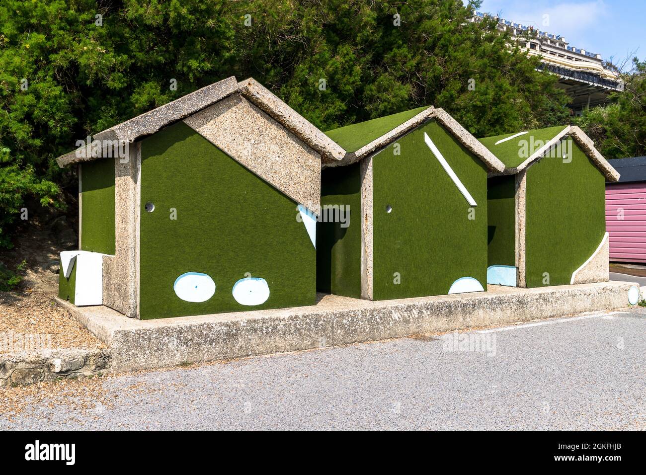 Strange huts put together with what looks like crazy golf boards, seen