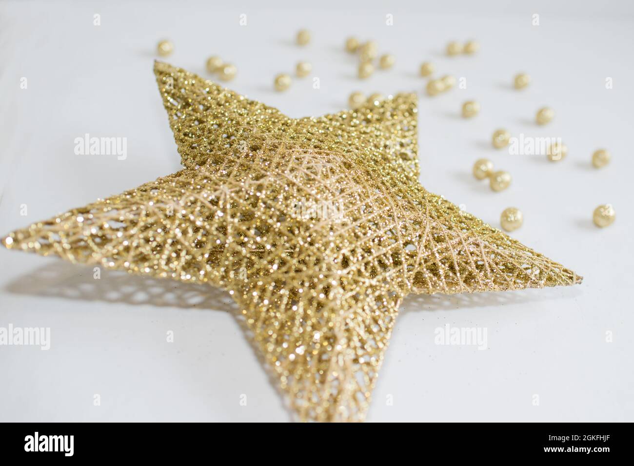 Christmas star and small golden balls with white background Stock Photo ...