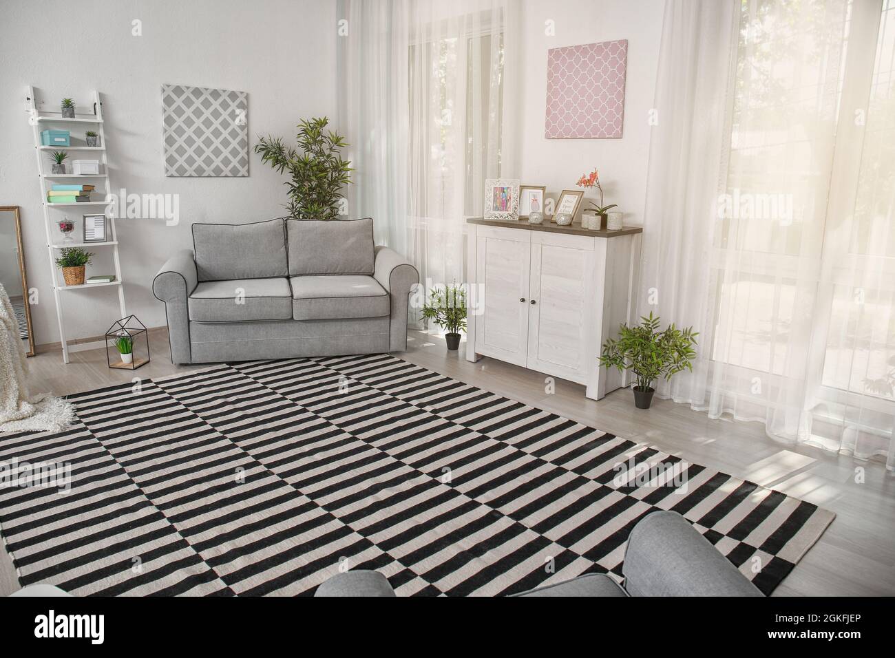 Modern living room design with big striped carpet Stock Photo - Alamy