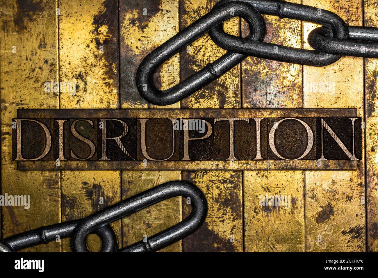Disruption text with steel chain on vintage textured grunge copper and gold background Stock Photo