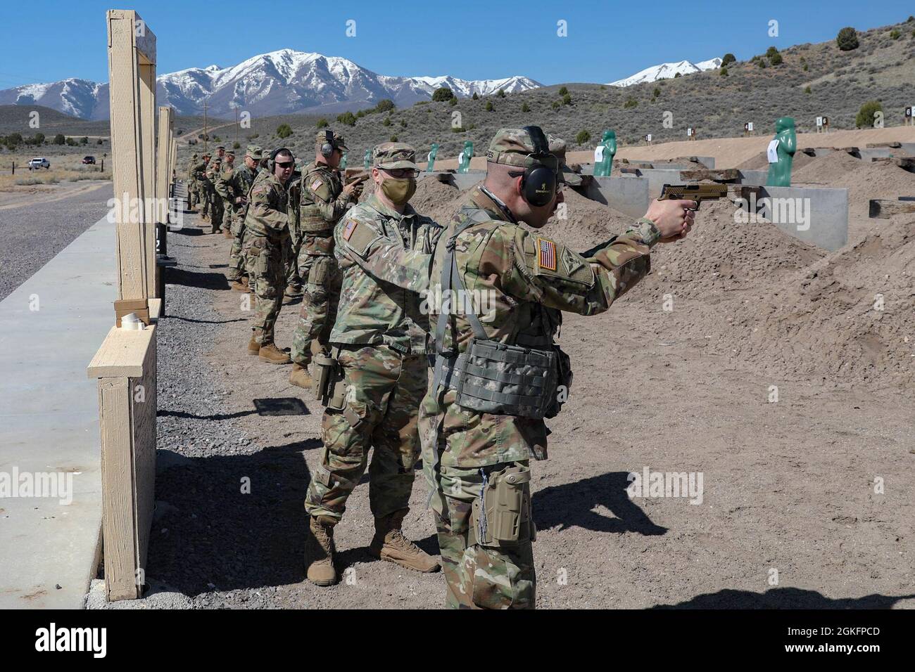 Soldiers familiarize themselves with their sidearms at the combat-pistol range and engage targets as part of the Utah National Guard Chaplain Conference at Camp Williams, Utah, April 10, 2021.  The conference provides specialized weapons training for military affairs specialists who must be prepared to defend chaplains when operating in a combat zone. Stock Photo