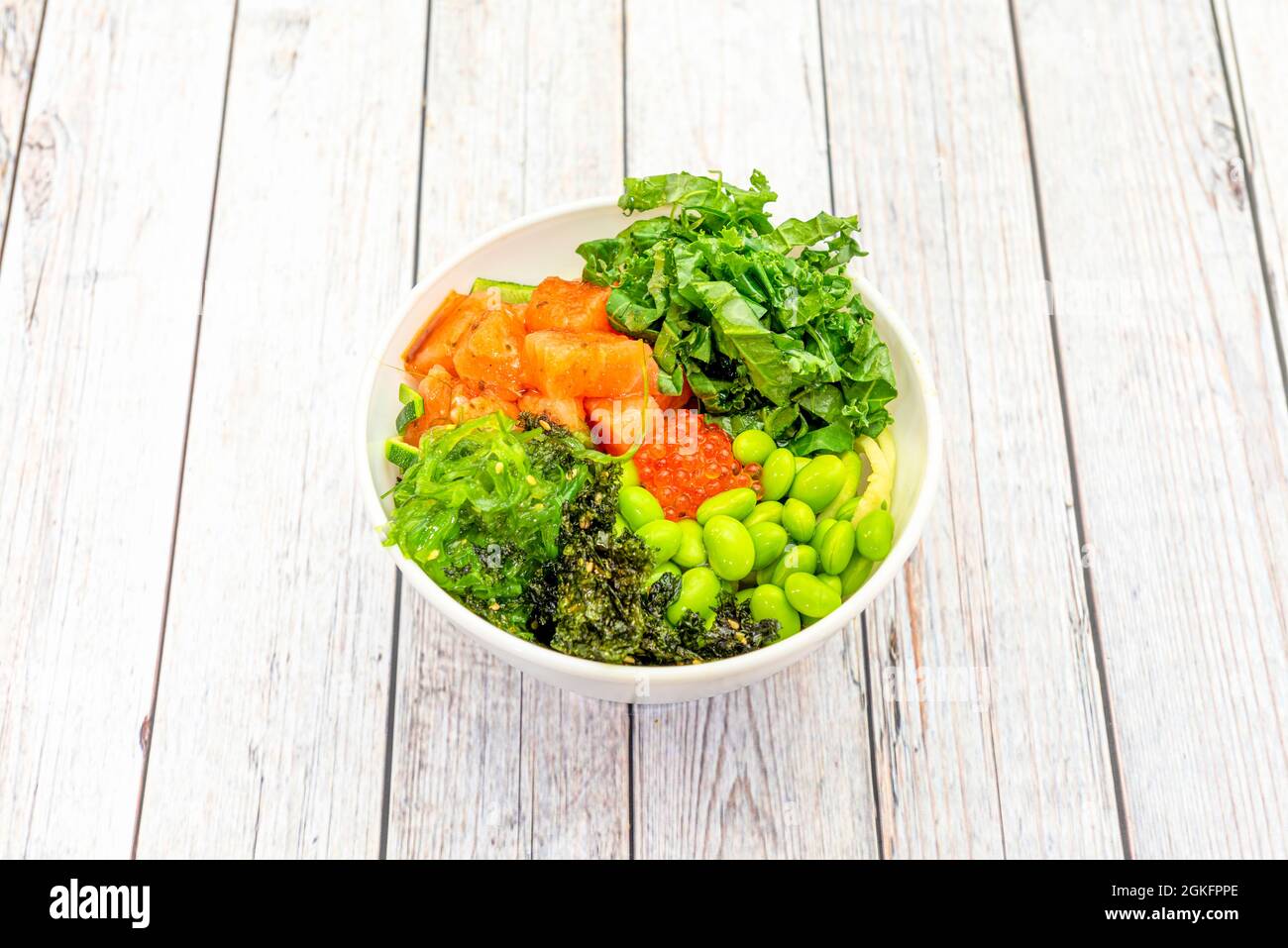 Norwegian salmon bowl with fish roe, wakame seaweed, chopped kale