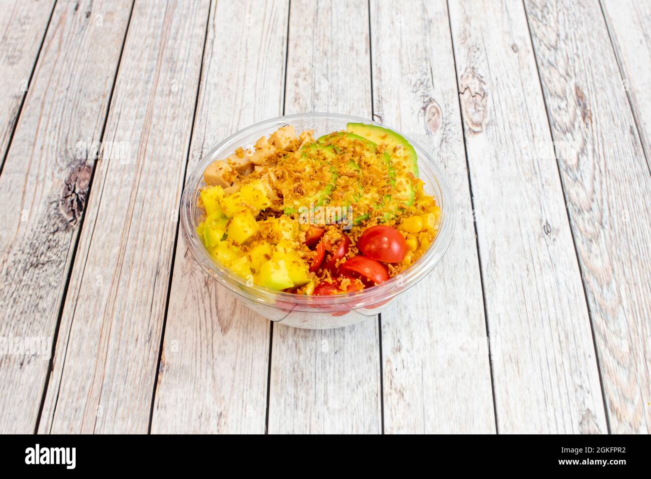 Healthy chicken poke bowl with mango tacos, sliced avocado, crunchy