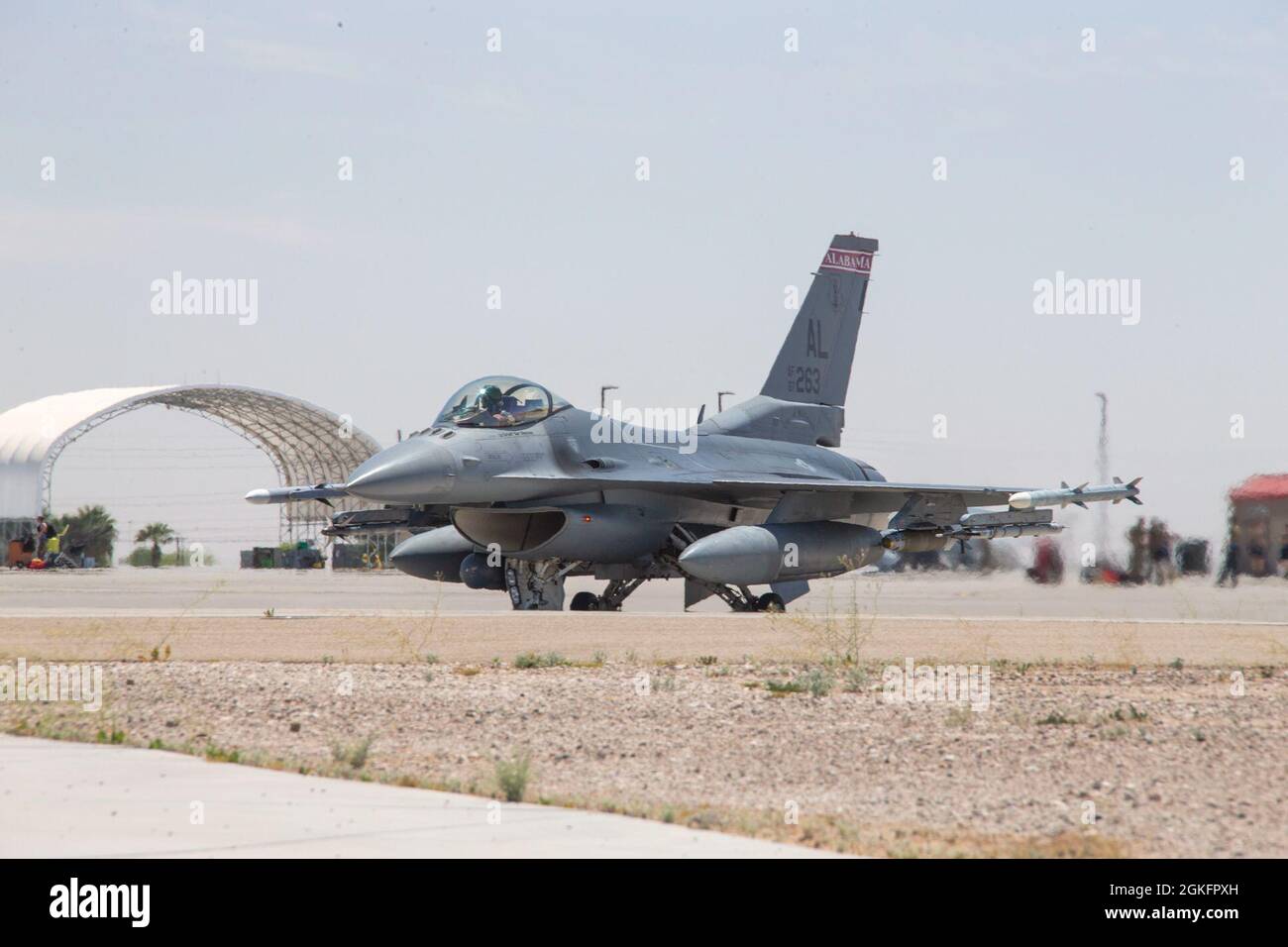 A U.S. Air Force F-16 Fighting Falcon, taxis the flight line prior to departure in support of Weapons and Tactics Instructor (WTI) course 2-21, at Marine Corps Air Station Yuma, Ariz., April 10, 2021. The WTI course is a seven-week training event hosted by Marine Aviation Weapons and Tactics Squadron One (MAWTS-1), providing standardized advanced tactical training certification of unit instructors qualifications to support Marine aviation training and readiness, and assists in developing and employing aviation weapons and tactics. Stock Photo