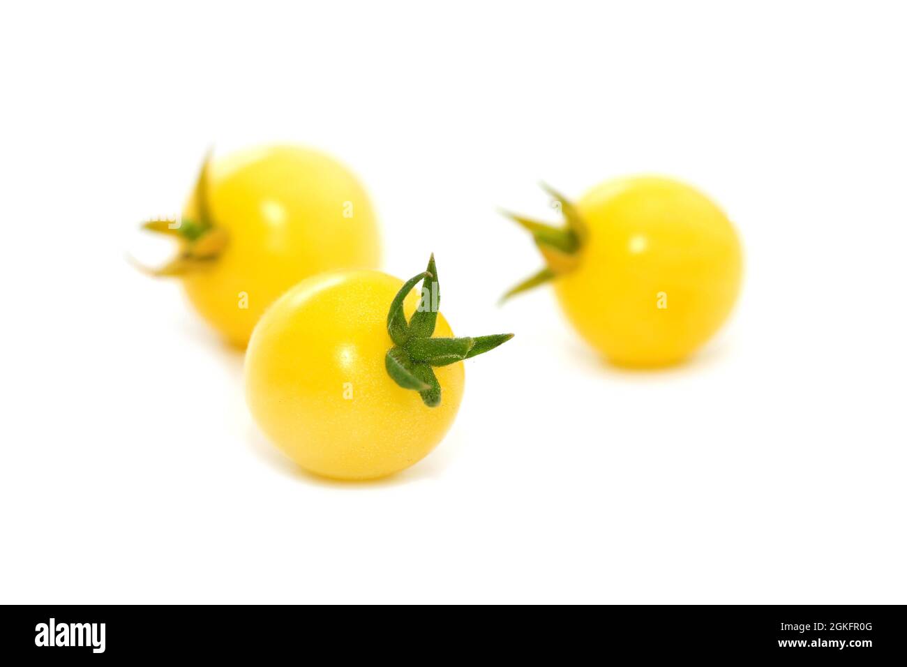 Yellow cherry tomatoes isolated on white Stock Photo