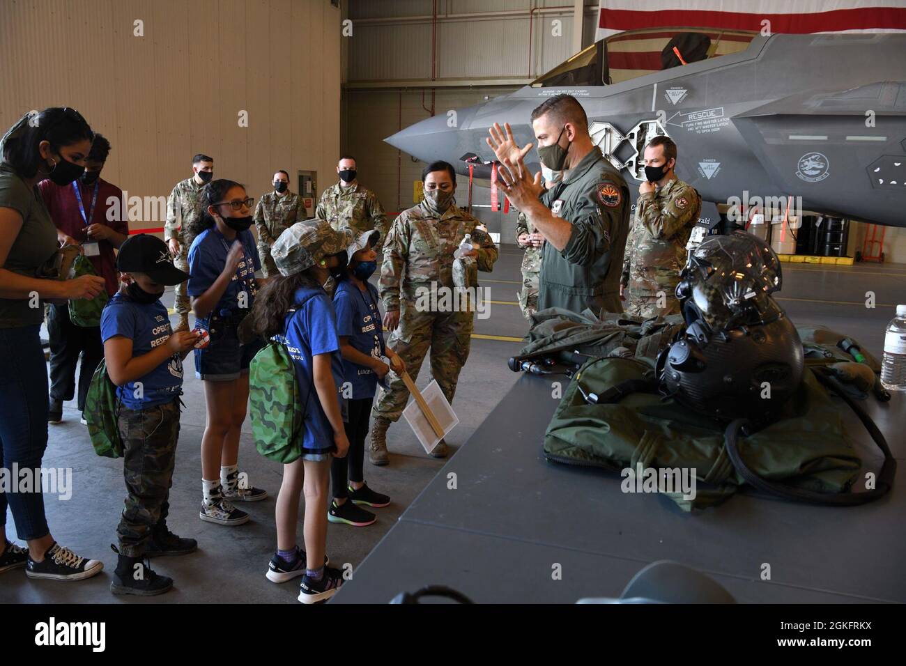 Reserve Citizen Airman Maj. Jordan Levine, 944th Operations Group instructor pilot, explains how pressure effects the body while flying the F-35 Lightning during Operation Reserve Kids at Luke Air Force Base, Arizona, April 10, 2021. The children were given the opportunity to hold the helmet, see the G-suit, and walk around the air frame. Stock Photo