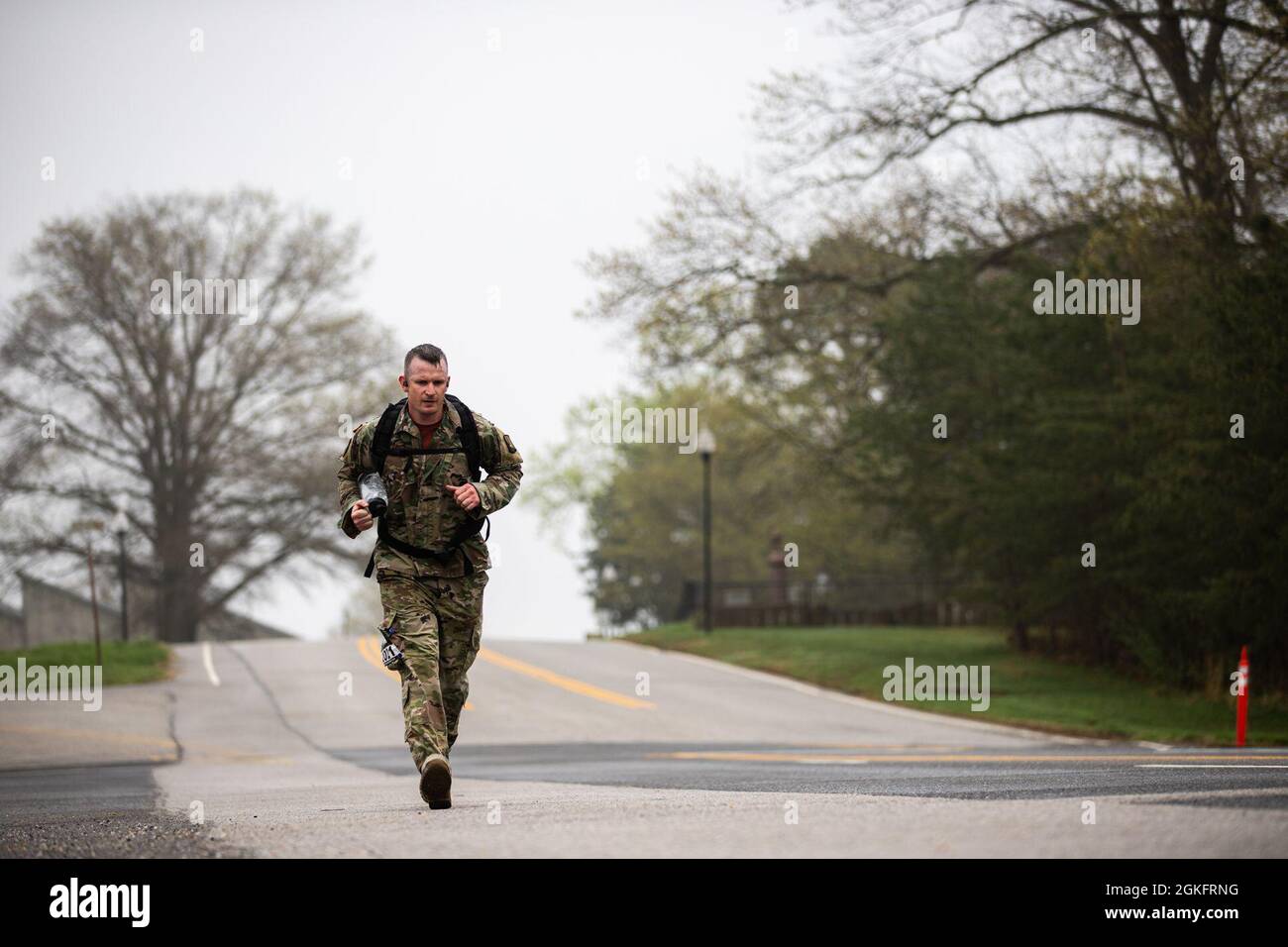 U.S. Army Sgt. 1st Class Nicholas Waddell, assigned to 55th Signal Company (Combat Camera) conduct the 26-mile Bataan Memorial Death March on Fort George G. Meade, Maryland, April 10, 2021. The Bataan Death March took place in April 1942, where American and Filipino prisoners of war were forced to walk 66 miles. Stock Photo