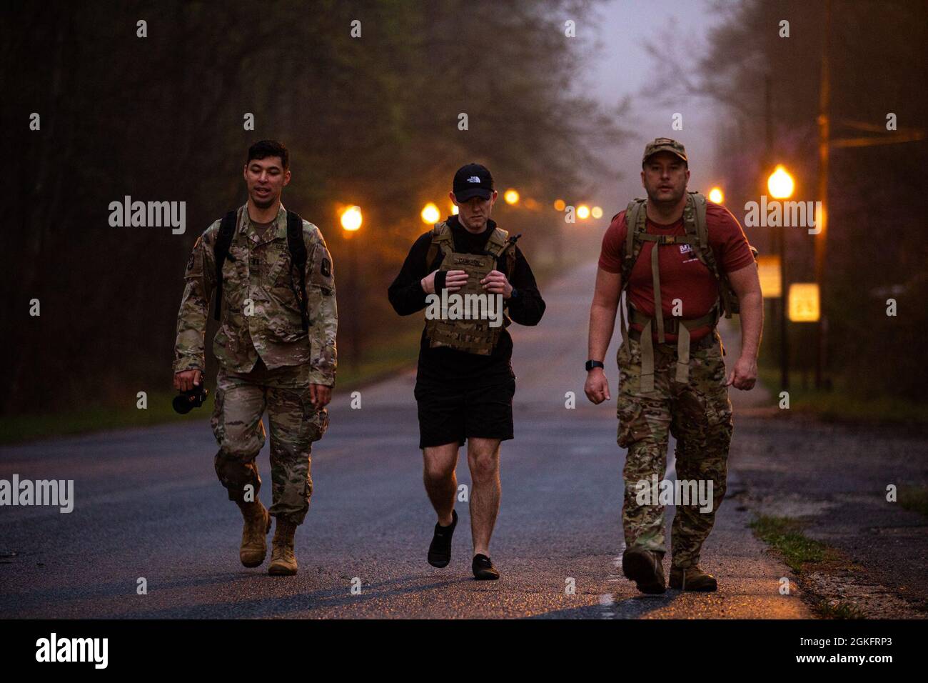 U.S. Army Capt. Phillip Lee, Staff Sgt. Brandon Franklin and Spc. Christopher Cameron conduct the 26-mile Bataan Memorial Death March on Fort George G. Meade, Maryland, April 10, 2021. The Bataan Death March took place in April 1942, where American and Filipino prisoners of war were forced to walk 66 miles. Stock Photo