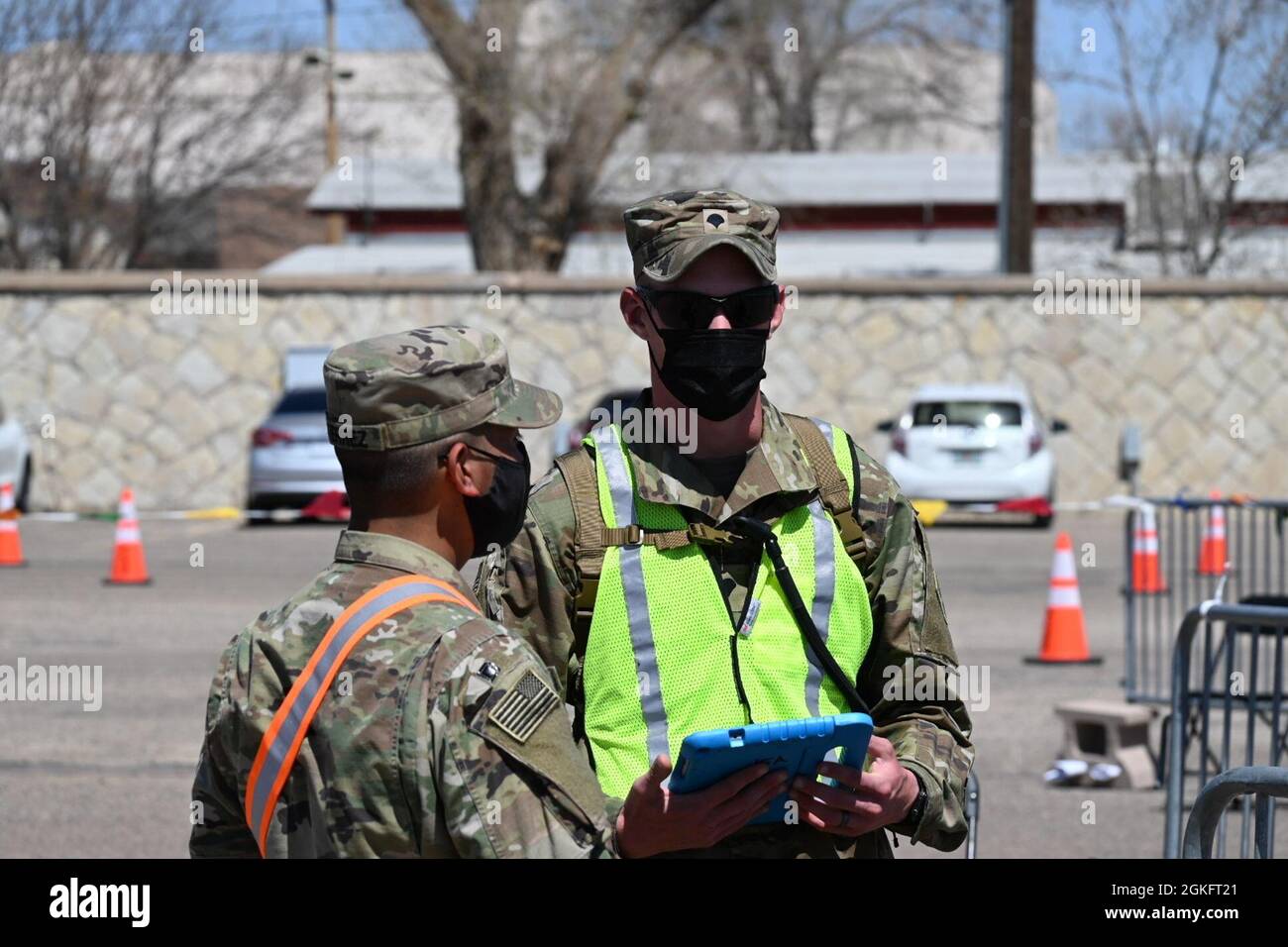 U.S. Army Pfc. Pedro Gutierrez, left, and Spc. Steven Prybylla, right, both assigned to the 3rd Squadron, 61st Cavalry Regiment, train on the vaccination check-in system at the drive-up lanes at the Community Vaccination Site (CVS) in Pueblo, Colorado, April 11, 2021. The drive-up lanes enable community members to acquire their COVID vaccination without having to exit their vehicles. U.S. Northern Command, through U.S. Army North, remains committed to providing continued, flexible Department of Defense support to the Federal Emergency Management Agency as part of the whole-of-government respon Stock Photo