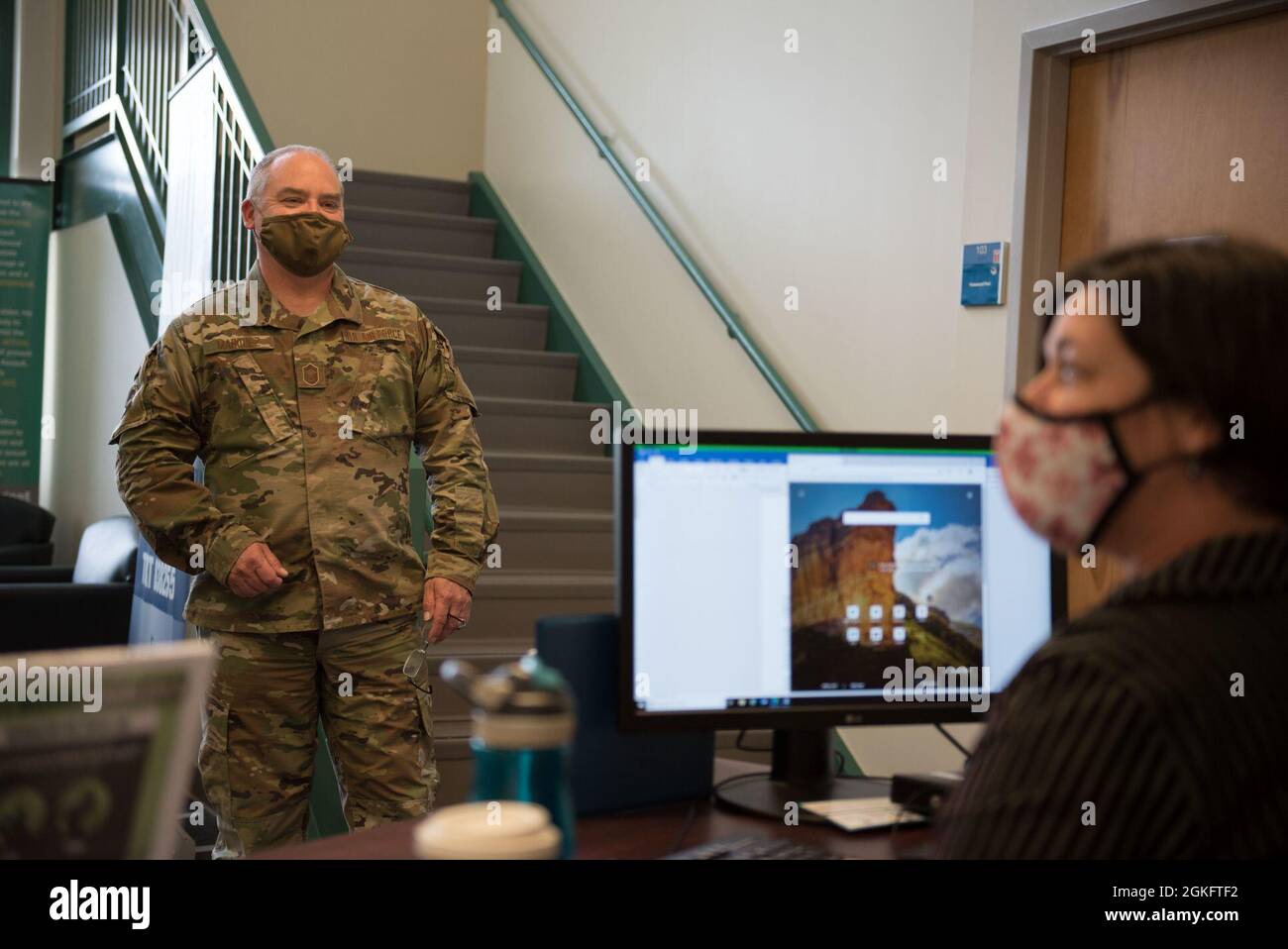 Members of the 102nd Intelligence Wing follow rules and regulations while at drill to keep everyone safe on Otis Air National Guard Base, Massachusetts, April 11, 2021. Precautions such as entry screening questions and temperature checks at each building entrance are key to a safe work environment and contact tracing. Stock Photo