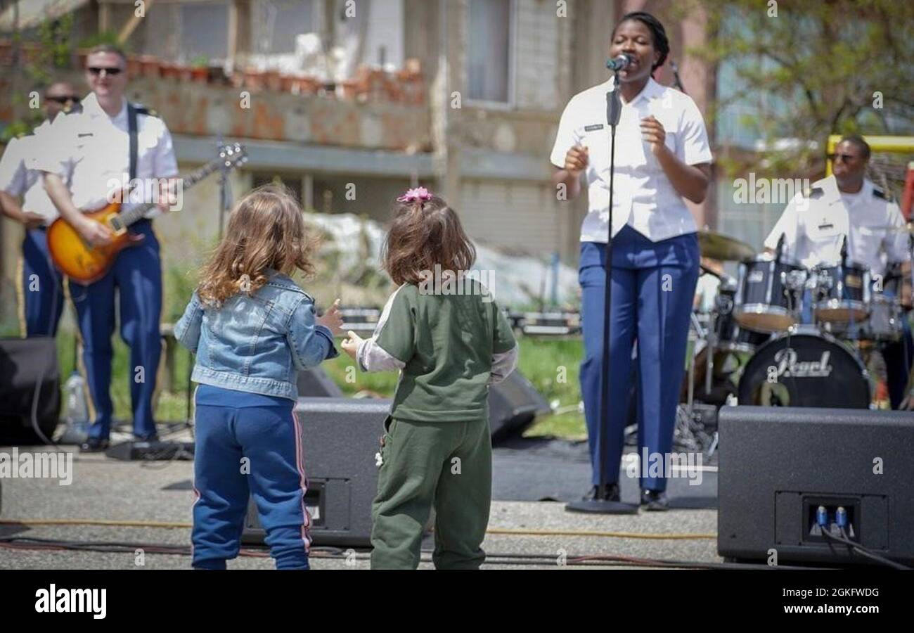 SPC. Stephania Ozokwere, vocalist, U.S. Army Europe and Africa Band and  Chorus shown here performing in front of local children, recently performed  the Greek Folk Song, Dance of Zalongo to commemorate Greek