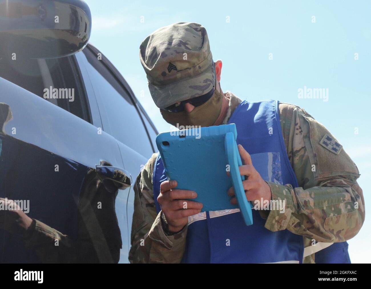 U.S. Army Sgt. Casey Bergmann, a combat medic assigned to 2nd Brigade, 4th Infantry Division, assists a community member in Pueblo, Colorado, April 12, 2021. The Soldiers deployed from Fort Carson, Colorado, in support of the continued Department of Defense COVID response operations to help communities in need. U.S. Northern Command, through U.S. Army North, remains committed to providing continued, flexible Department of Defense support to the Federal Emergency Management Agency as part of the whole-of-government response to COVID-19. Stock Photo