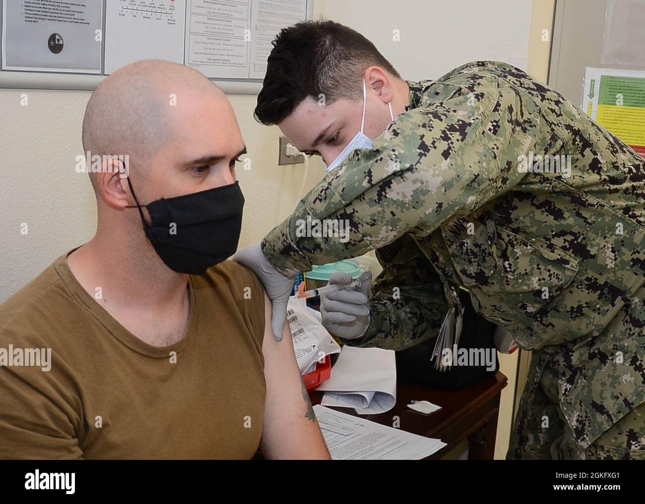 Hospitalman Devan Wilson, a Hospital Corpsman assigned to Navy Medicine Readiness and Training Unit Kingsville administers a COVID-19 vaccination to CS1 Jaycen Ferreira at Naval Branch Health Clinic Kingsville. COVID-19 vaccines are available at NBHC Kingsville for all TRICARE beneficiaries age 18 and older. Stock Photo