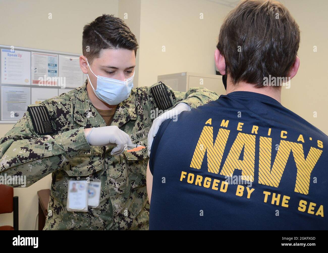 Hospitalman Devan Wilson, a Hospital Corpsman assigned to Navy Medicine Readiness and Training Unit Kingsville administers a COVID-19 vaccination to a patient at Naval Branch Health Clinic Kingsville. COVID-19 vaccines are available at NBHC Kingsville for all TRICARE beneficiaries age 18 and older. Stock Photo