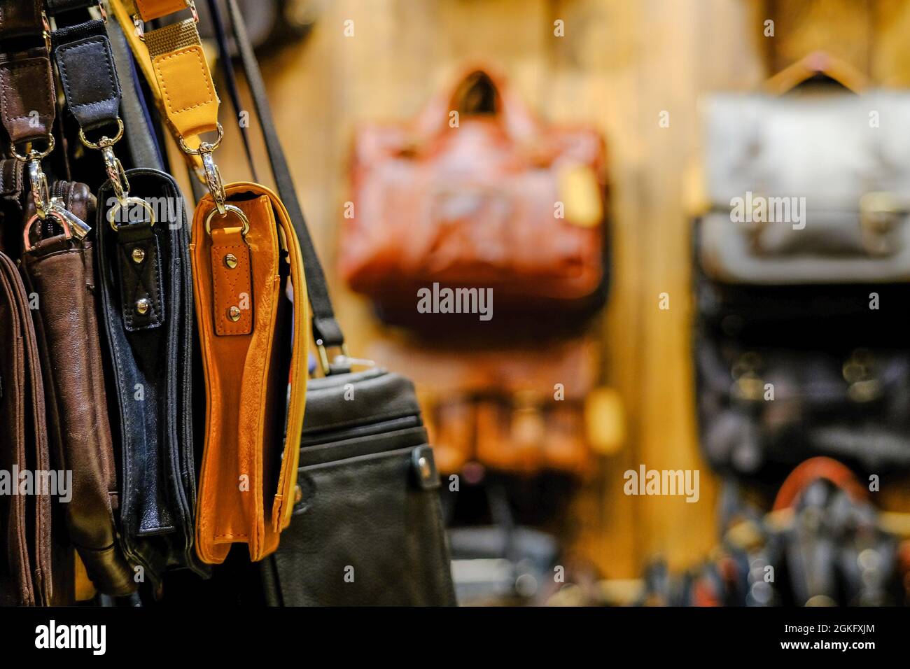 Leather bags of business style in different colors. The assortment is on the store counter. Handmade concept Stock Photo