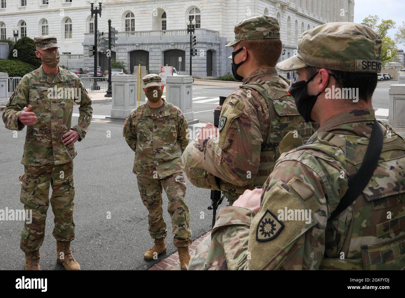 U.S. Army Col. Brian Wertzler, left, deputy adjutant general, Kentucky National Guard, and Command Sgt. Maj. Jesse Withers, center, state command sergeant major, Kentucky National Guard, addresses a group of Soldiers near the U.S. Capitol in Washington, D.C., April 12, 2021. The National Guard has been requested to continue supporting federal law enforcement agencies with security, communications, medical evacuation, logistics, and safety support to state, district and federal agencies through mid-May. Stock Photo