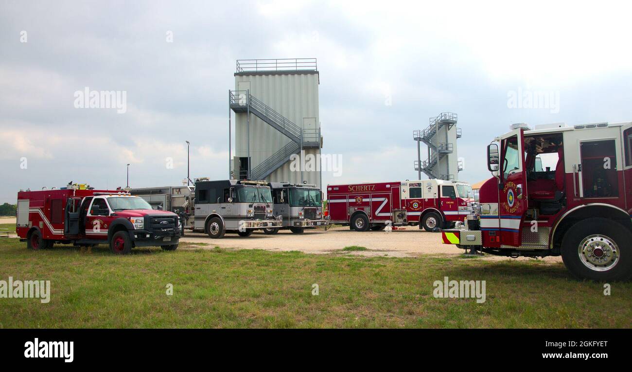 U.S. Air Force 902nd Civil Engineer Squadron Fire Emergency Services, Schertz Fire Rescue, and Cibolo Fire Department vehicles surround a fire training facility at Joint Base San Antonio-Randolph, Texas, April 12, 2021. The training provided consistency in the techniques used by JBSA firefighters and members of both community fire departments, since all three departments fall under a mutual-aid agreement. Stock Photo