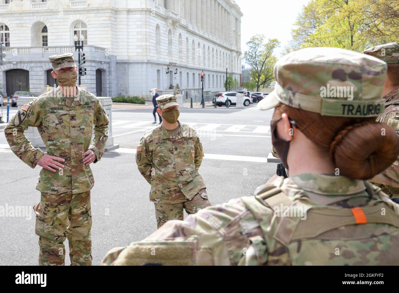 U.S. Army Col. Brian Wertzler, left, deputy adjutant general, Kentucky National Guard, and Command Sgt. Maj. Jesse Withers, center, state command sergeant major, Kentucky National Guard, addresses a group of Soldiers near the U.S. Capitol in Washington, D.C., April 12, 2021. The National Guard has been requested to continue supporting federal law enforcement agencies with security, communications, medical evacuation, logistics, and safety support to state, district and federal agencies through mid-May. Stock Photo