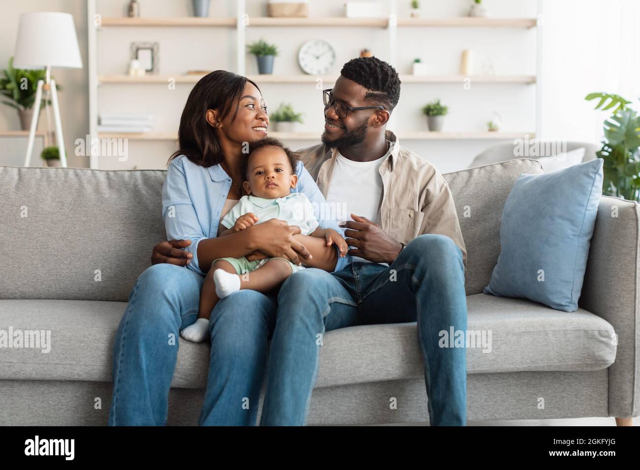 Portrait of happy black family smiling looking at each other Stock ...