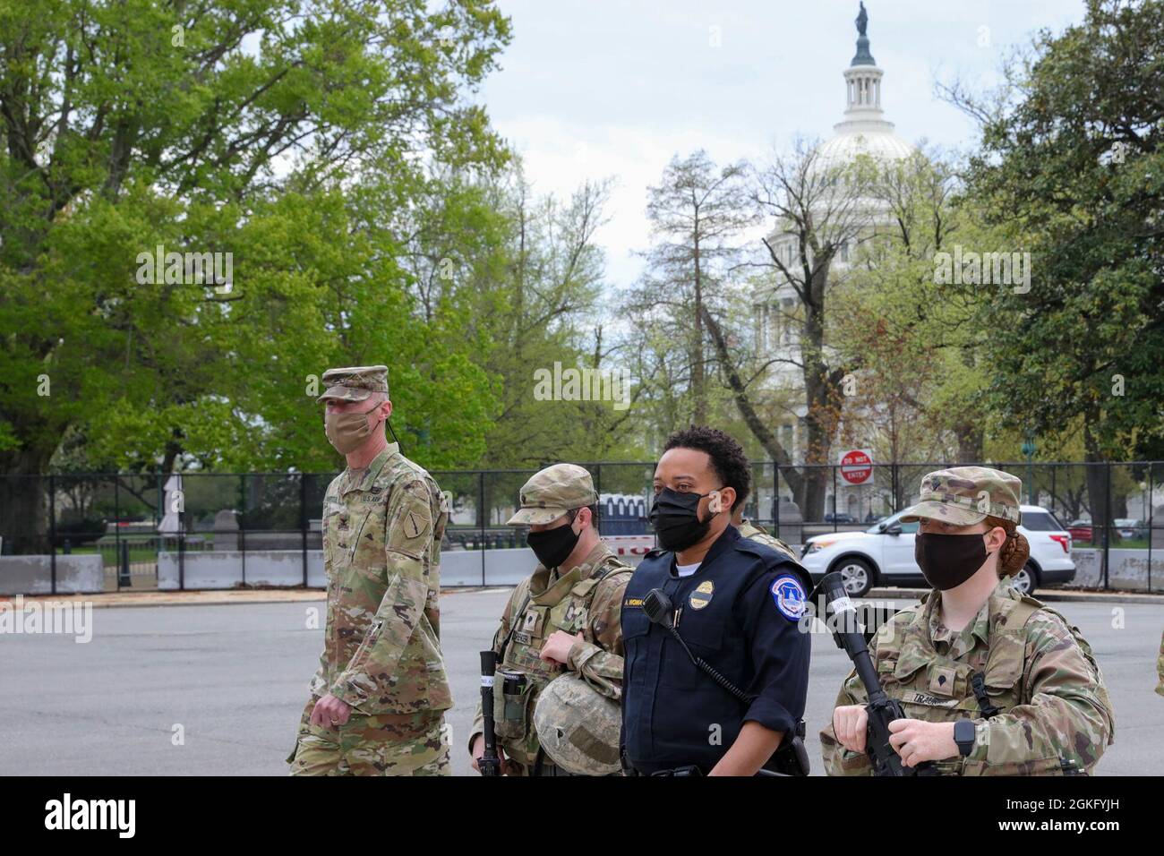 U.S. Capitol Police Officer Andre Womack II, center, conducts a patrol with U.S. Army Col. Brian Wertzler, left, deputy adjutant general, Kentucky National Guard, along with two other Soldiers, near the U.S. Capitol in Washington, D.C., April 12, 2021. The National Guard has been requested to continue supporting federal law enforcement agencies with security, communications, medical evacuation, logistics, and safety support to state, district and federal agencies through mid-May. Stock Photo