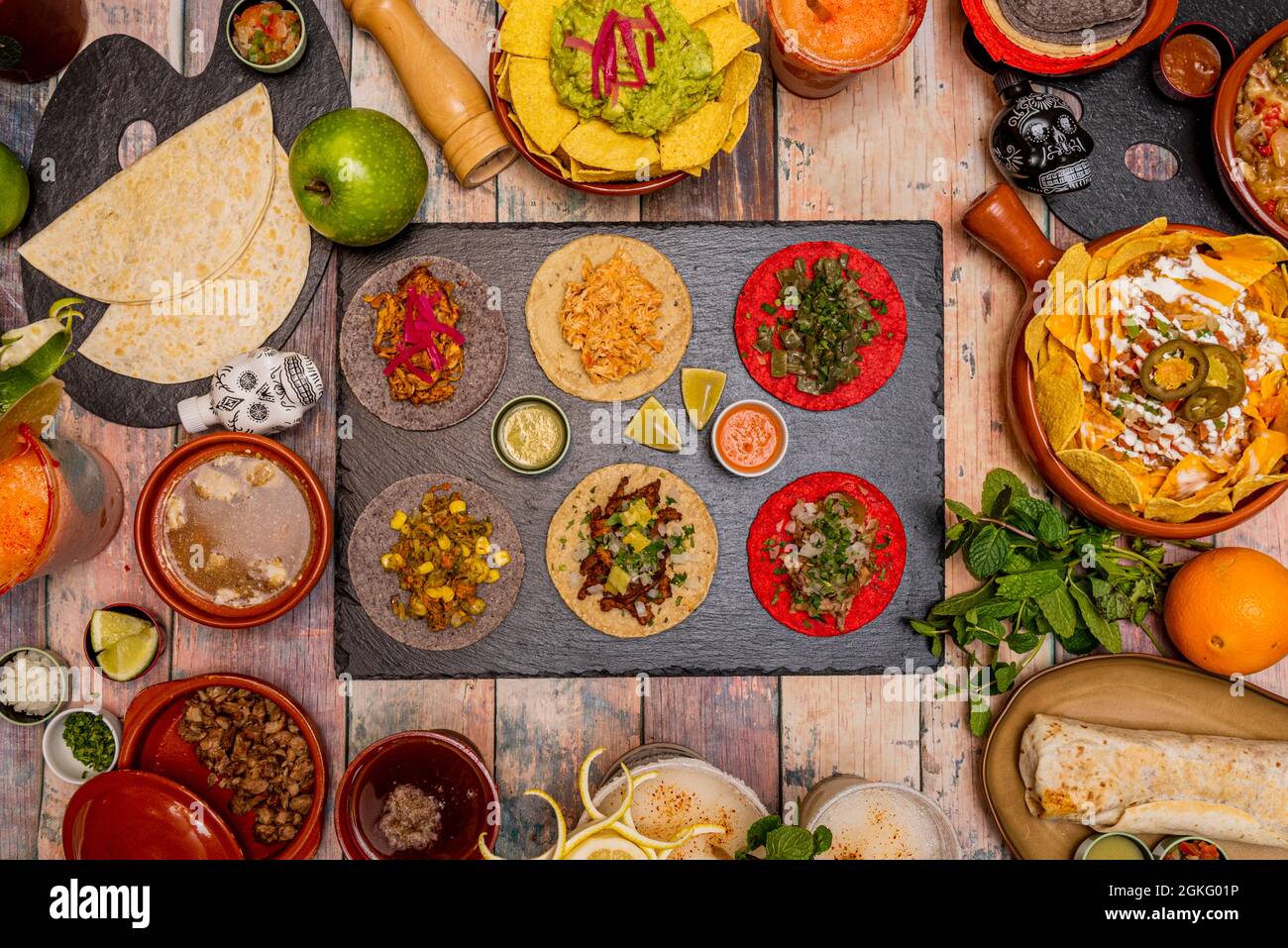 Set of popular dishes of Mexican culture. Cochinita tacos, pastor tacos, pulled pork, nopales. Nachos with guacamole, complete nachos, burrito, beef w Stock Photo
