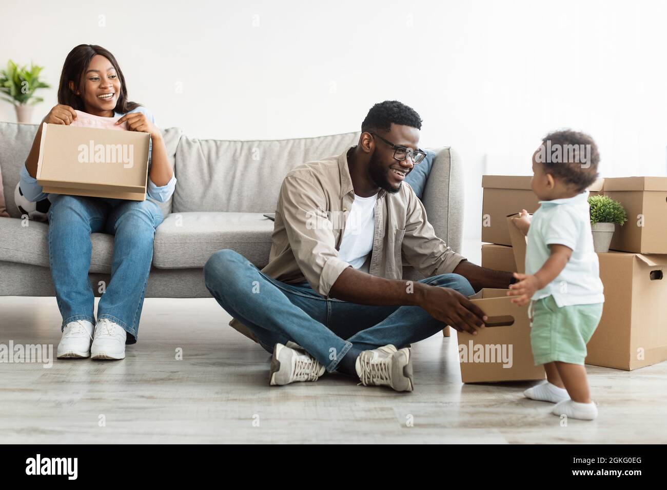 Happy African American family moving in new apartment Stock Photo - Alamy