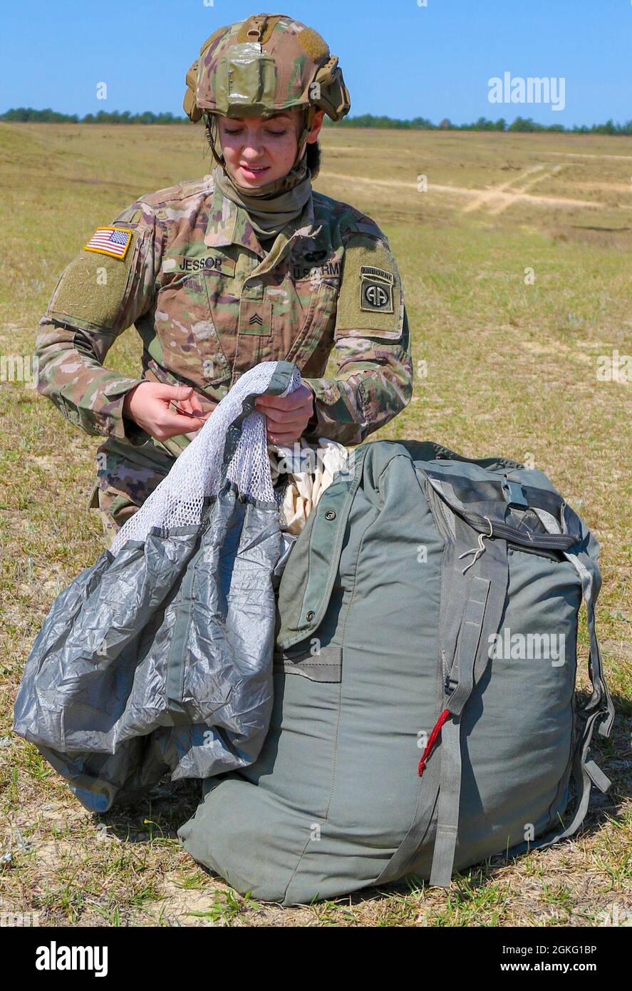 A Paratrooper from the 82nd Airborne Division packs her T11 parachute