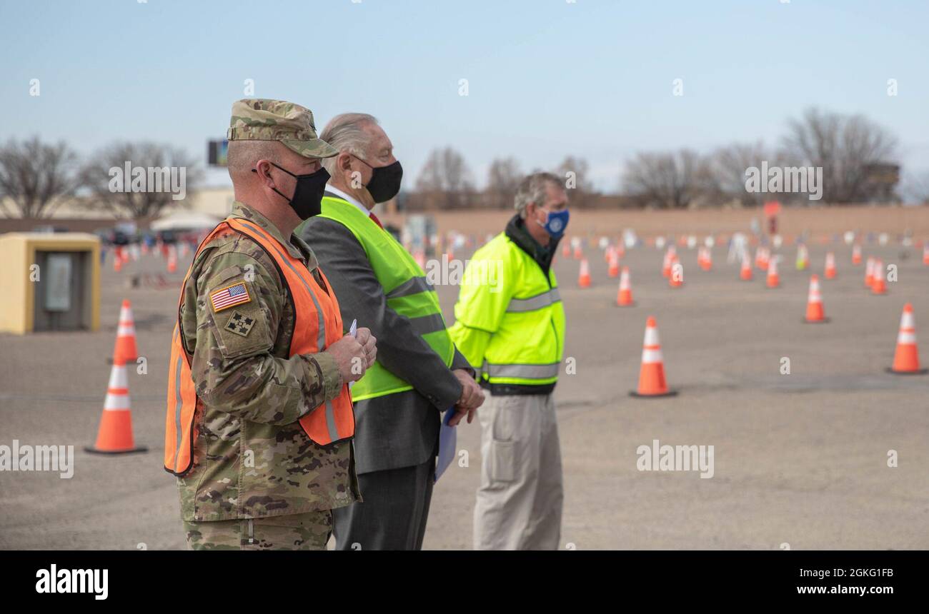 U.S. Army Col. Brandon Newton (left), Defense Coordinating Officer for the Federal Emergency Management Agency (FEMA) Region 8, Pueblo, Colorado Mayor Nicholas A. Gradisar (middle), and Michael J. Willis (right), Director of the Colorado Office of Emergency Management, listen to a speech at the Pueblo Community Vaccination Site (CVS) in Pueblo, Colorado, April 14, 2021. Army, FEMA, state and local leadership gathered at a media event for the transition of the Pueblo CVS to a federally run site. U.S. Northern Command, through U.S. Army North, remains committed to providing continued, flexible D Stock Photo