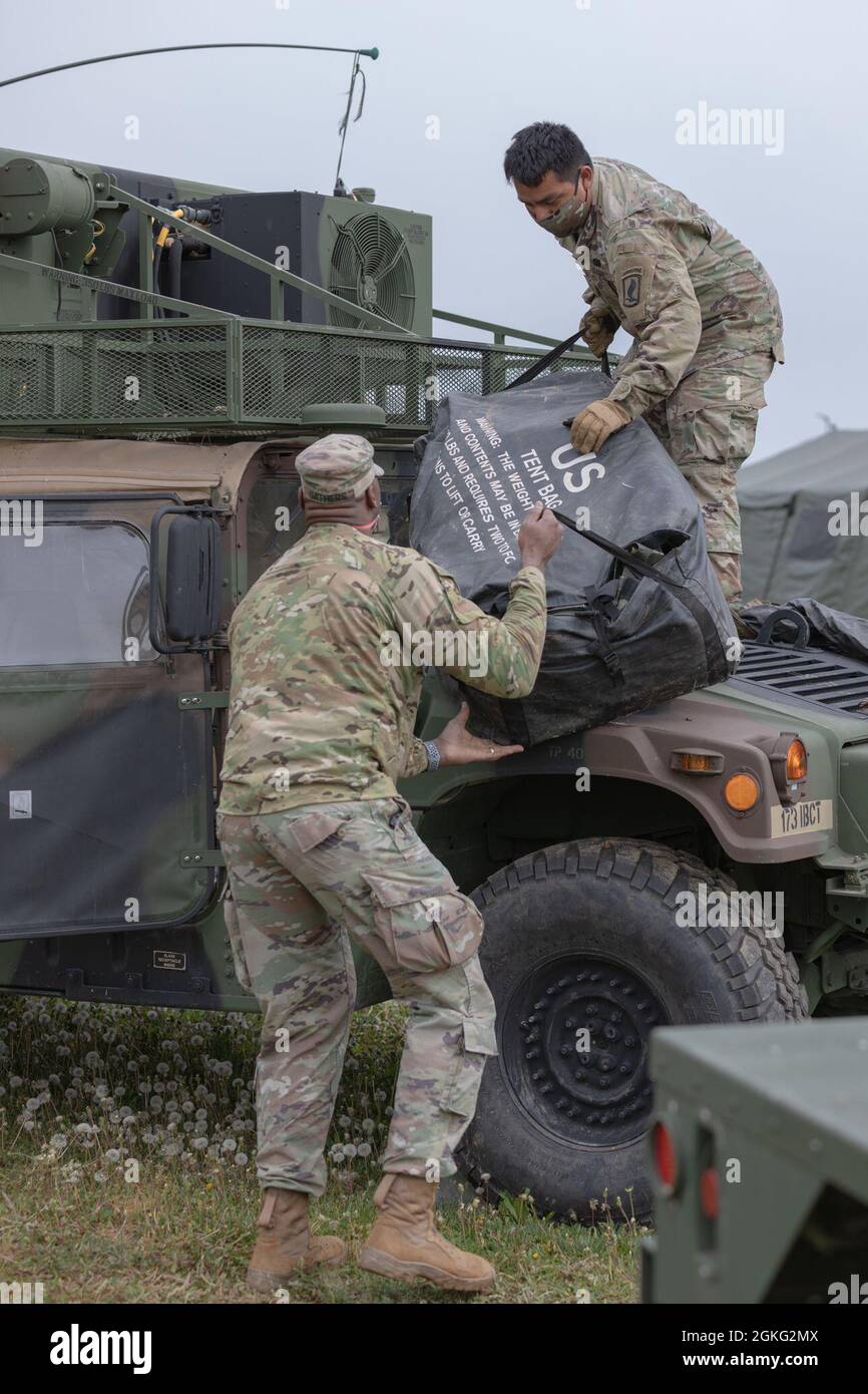 U.S. Army paratroopers assigned to Headquarters, Headquarters Company load  a tent on a vehicle during a command post exercise (CPX) on Caserma Del Din  in preparation for Exercise Swift Response / Defender