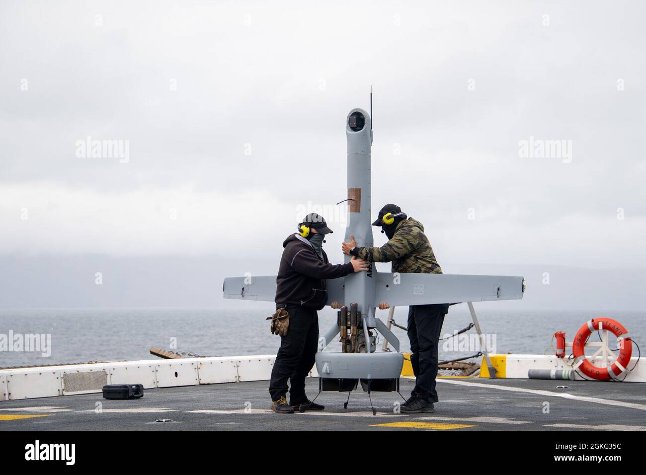 PACIFIC OCEAN (April 13, 2021) — Ryan Pullen, left, and Joshua Fasnacht, representatives from Martin UAV, prepare a V-Bat vertical take-off and landing unmanned aerial vehicle for launch on the flight deck of amphibious transport dock USS Portland (LPD 27), April 13. Portland is underway conducting routine operations in U.S. Third Fleet. Stock Photo