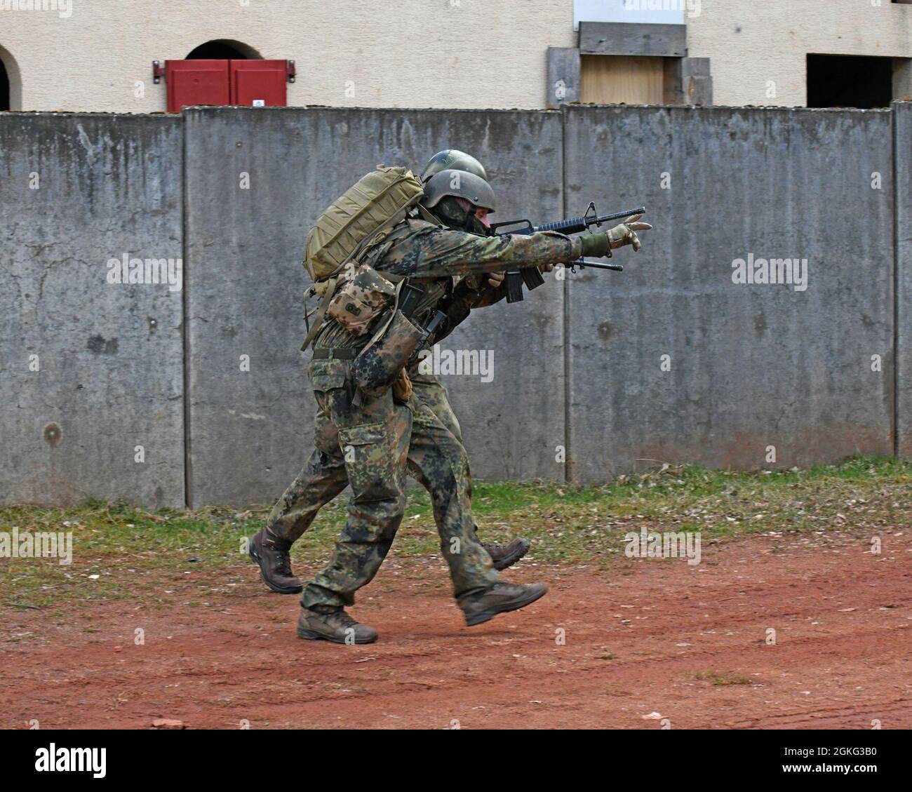 German (Bundeswehr) Soldiers respond to a simulated wounded Military Working dog during a K-9 Tactical Combat Casualty Care Short Course in Baumholder, Germany April 13, 2021 . The 64th MED DET hosted a three day course that taught handlers and medics MWD life saving techniques and procedures. Stock Photo