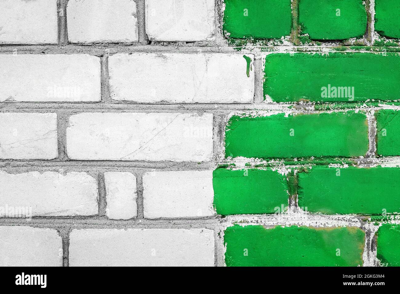 Old white dirty brick art wall design texture with green paint background. Stock Photo