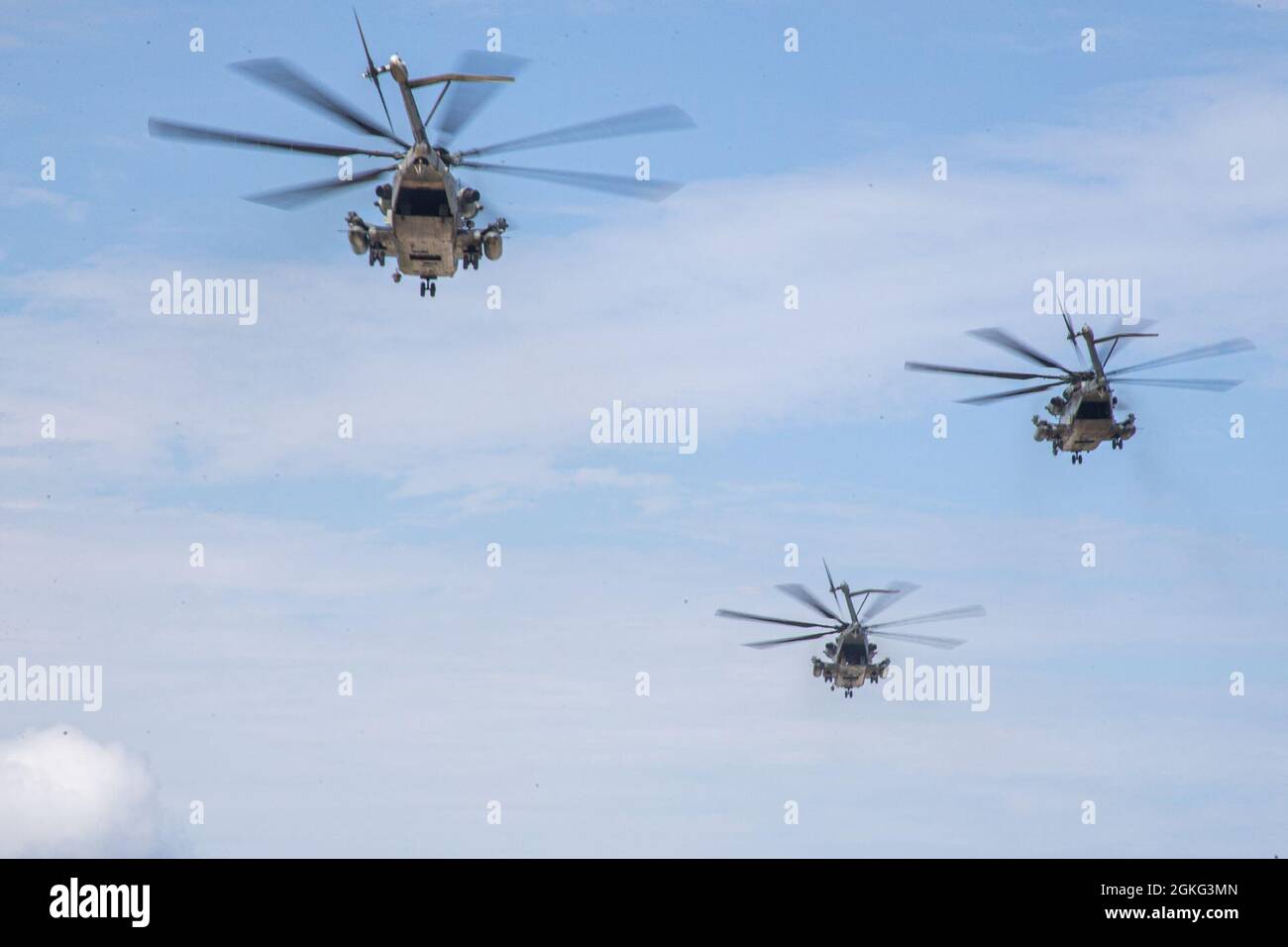 U.S. Marine Corps CH-53E Super Stallion helicopters assigned to Marine Heavy Helicopter Squadron (HMH) 465 fly in support of a Marine Corps Combat Readiness Evaluation (MCCRE) at the Ie Shima training facility, Okinawa, Japan, April 13, 2021.  The MCCRE creates a challenging, realistic training environment that produces combat-ready forces capable of operating as a deployed unit at any time. Stock Photo