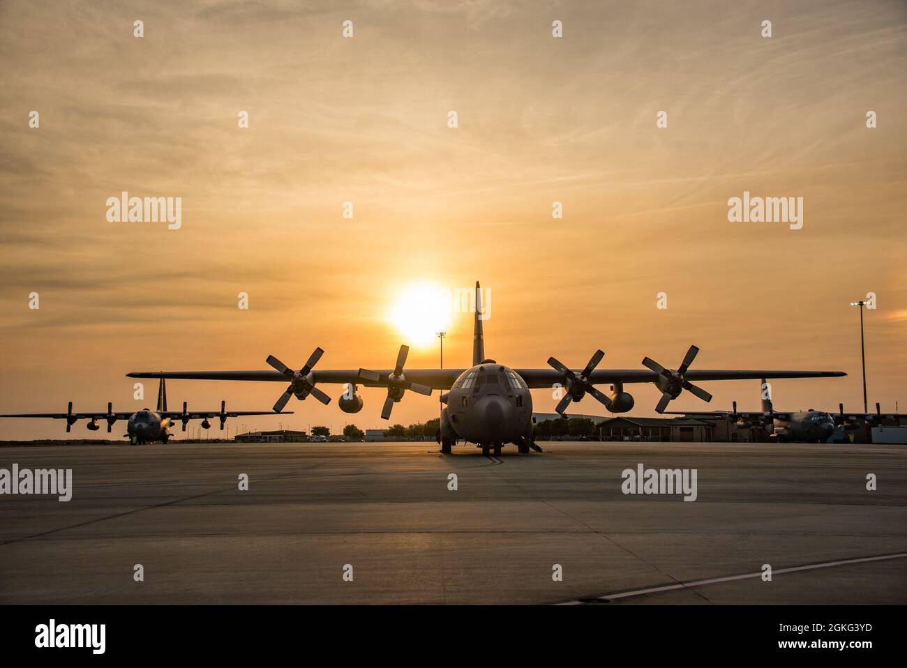Three U.S. Air Force C-130 Hercules aircraft sit on the flight line ...