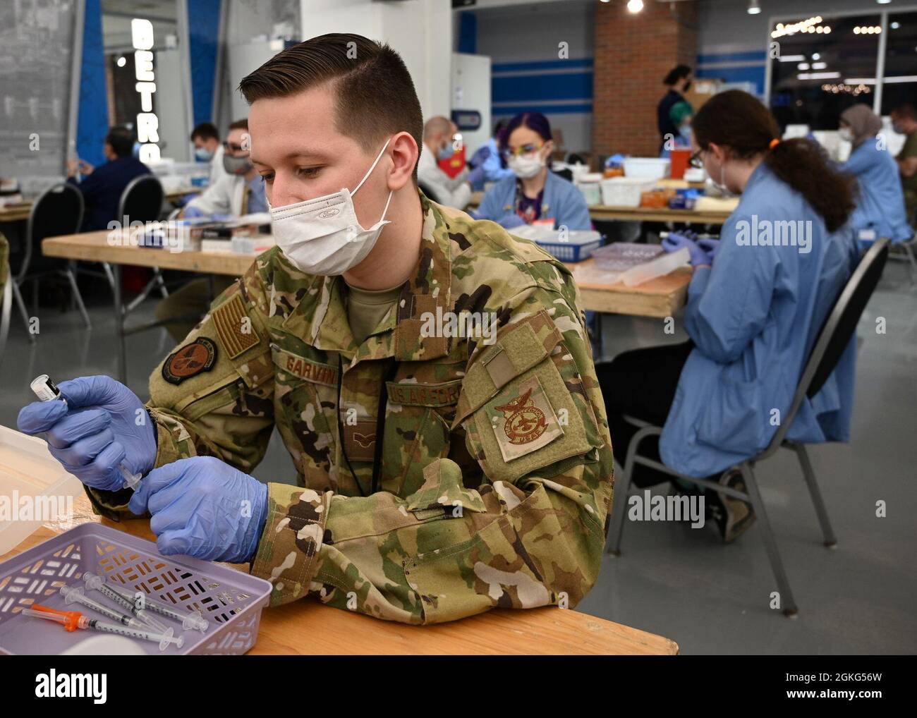 U.S. Air Force Senior Airman Michael Garvin, an Orwell, New York, native and fire fighter with the 628th Civil Engineering Squadron, 628th Air Base Wing stationed at Joint Base Charleston, South Carolina, draws a COVID-19 vaccine at the state-led, federally-supported Ford Field Community Vaccination Center in Detroit, Michigan, April 14, 2021. Garvin is part of a group of Airmen assigned to 1st Detachment, 64th Air Expeditionary Group, that are assisting with the vaccination efforts. Garvin's main responsibility is supporting local community members by preparing COVID-19 vaccines for vaccinato Stock Photo