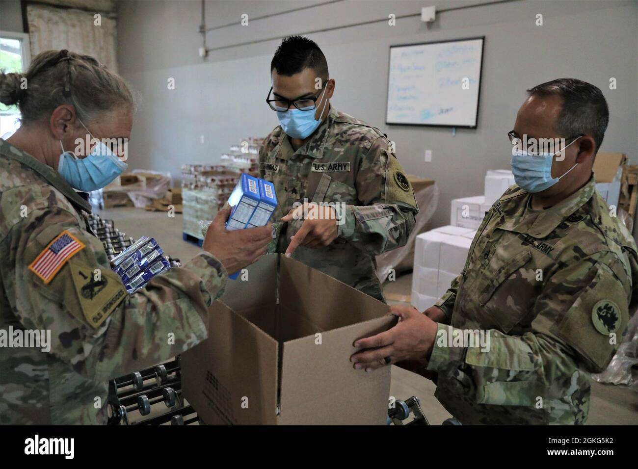 U.S. Army Soldiers assigned to the Mariette-based 78th Troop Command, Georgia Army National Guard pack a box of food April 14, 2021, at America’s Second Harvest of Coastal Georgia food bank in Savannah, Georgia. The Georgia Guardsmen all reside in the Savannah area and were activated in response to the COVID-19 pandemic. Stock Photo