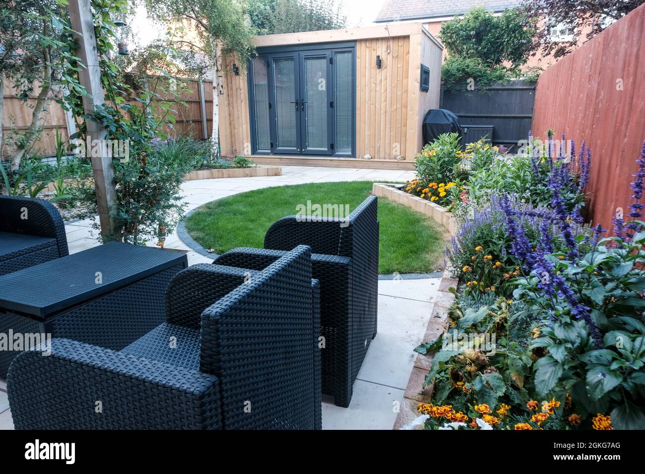Garden office and landscaped garden with furniture Stock Photo Alamy