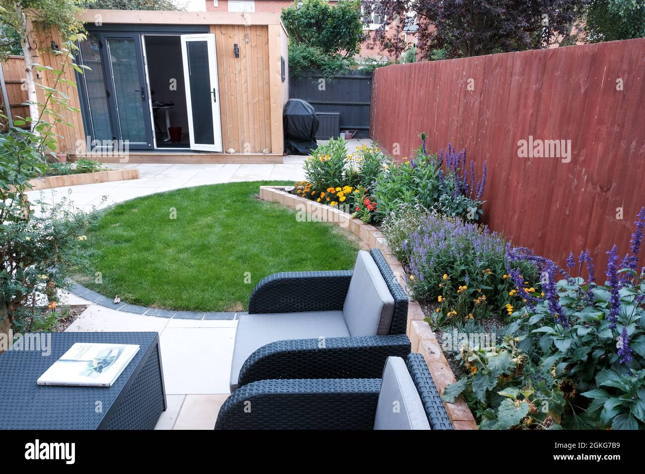 Garden office and landscaped garden with furniture Stock Photo Alamy