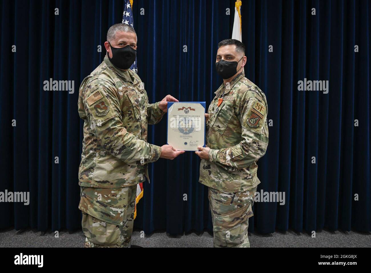 Col. Patrick Launey, 374th Mission Support Group commander, awards Lt. Col Jonathon Murray, 374th Security Forces Squadron commander, an Air Force Combat Action Medal at the Yokota professional development center, April 14, 2021. On March 15, 2007, the Secretary of the Air Force approved the establishment of the Air Force Combat Action Medal to recognize any military member of the Air Force (airman basic through colonel,) who actively participated in either air or ground combat. Lt. Col. Jonathon Murray was part of a team that fought out of an ambush in 2005 outside the Iraqi city of Tikrit wh Stock Photo