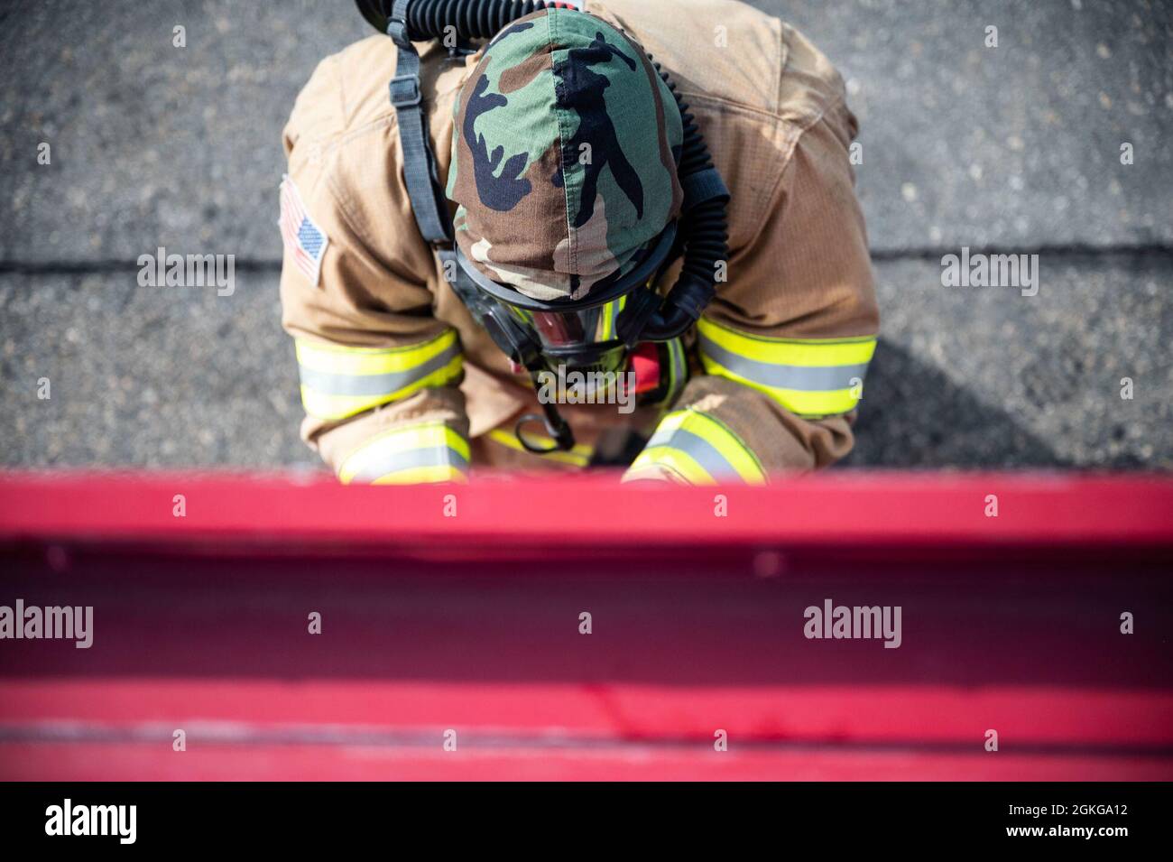 U.S. Air Force Airman 1st Class Ryan Brown, a 354th Civil Engineering Squadron (CES) firefighter, inspects a firetruck during a Joint Firefighter’s Integrated Response Ensemble (JFIRE), on Eielson Air Force Base, Alaska, April 15, 2021. The 354th CES fire department conducted a JFIRE exercise during phase II of Arctic Gold 21-2 to train both new and seasoned firefighters on how to respond to a wartime chemical, biological, radiological and nuclear attack. Stock Photo