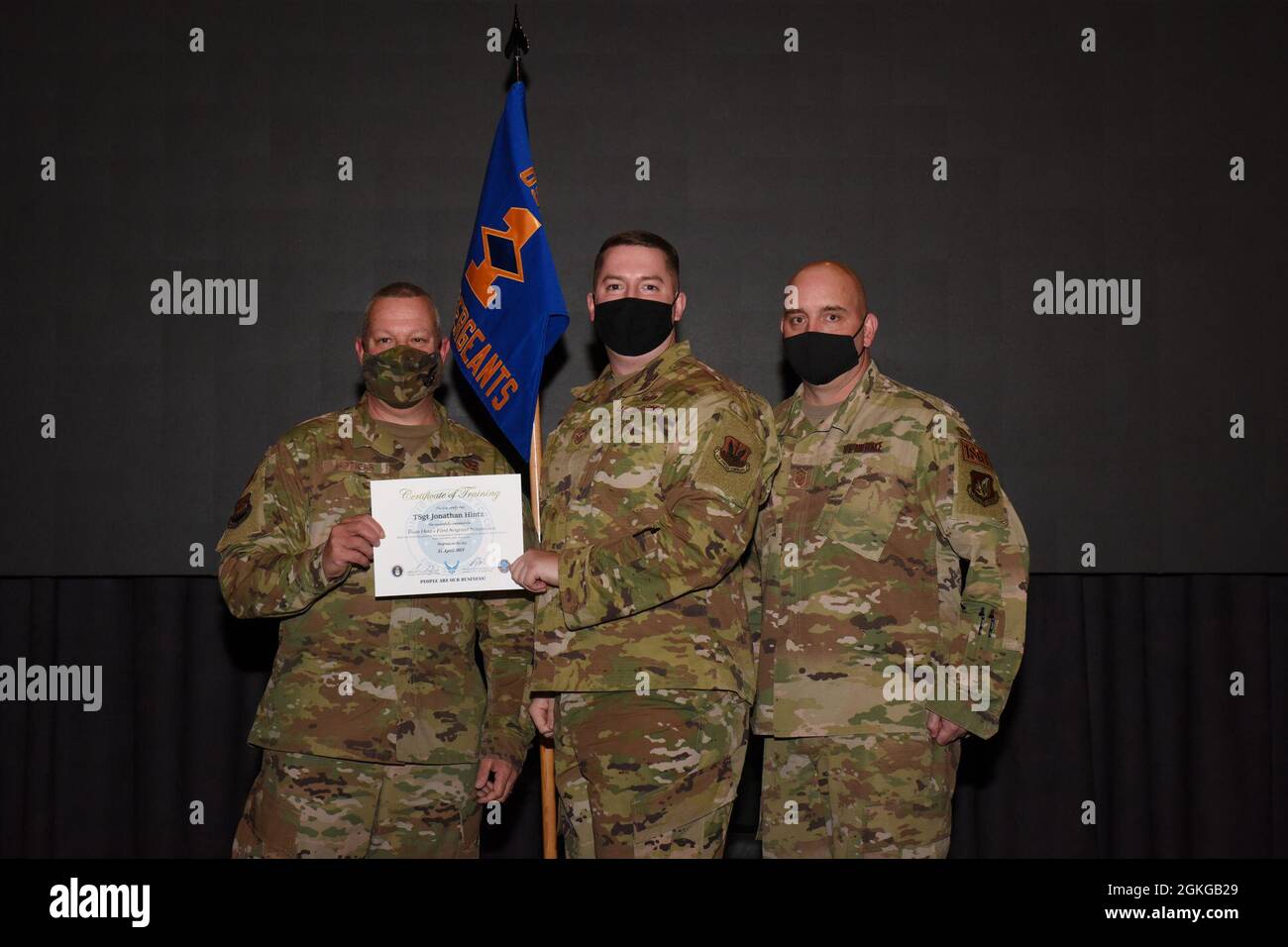 Tech. Sgt. Jonathan Hintz, 303rd Intelligence Squadron, accepts his ...