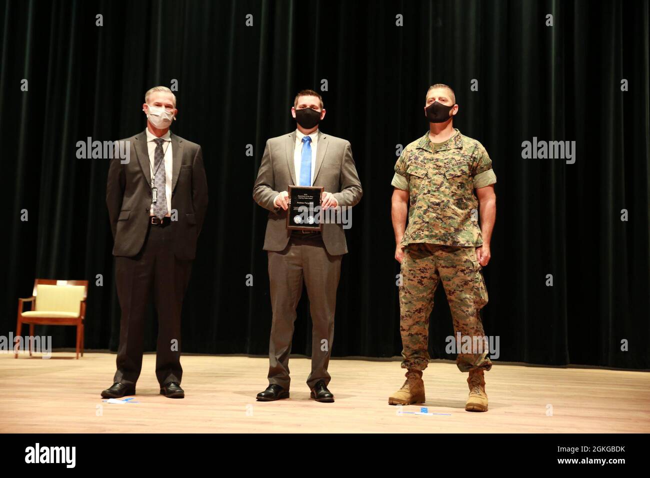 Rick Quade (far left), the U.S. Navy’s executive director for Innovation, Technology Requirements and Test and Evaluation, and Brig. Gen. A.J. Pasagian (far right), commander of Marine Corps Systems Command, pose with Andrew Ferguson, a test engineer for the Amphibious Vehicle Test Branch at Marine Corps Tactical Systems Support Activity, who received the Aspiring Tester Award-Civilian Category during MCSC’s DON Test & Evaluation Awards ceremony, April 15, aboard Marine Corps Base Quantico, Virginia. Stock Photo