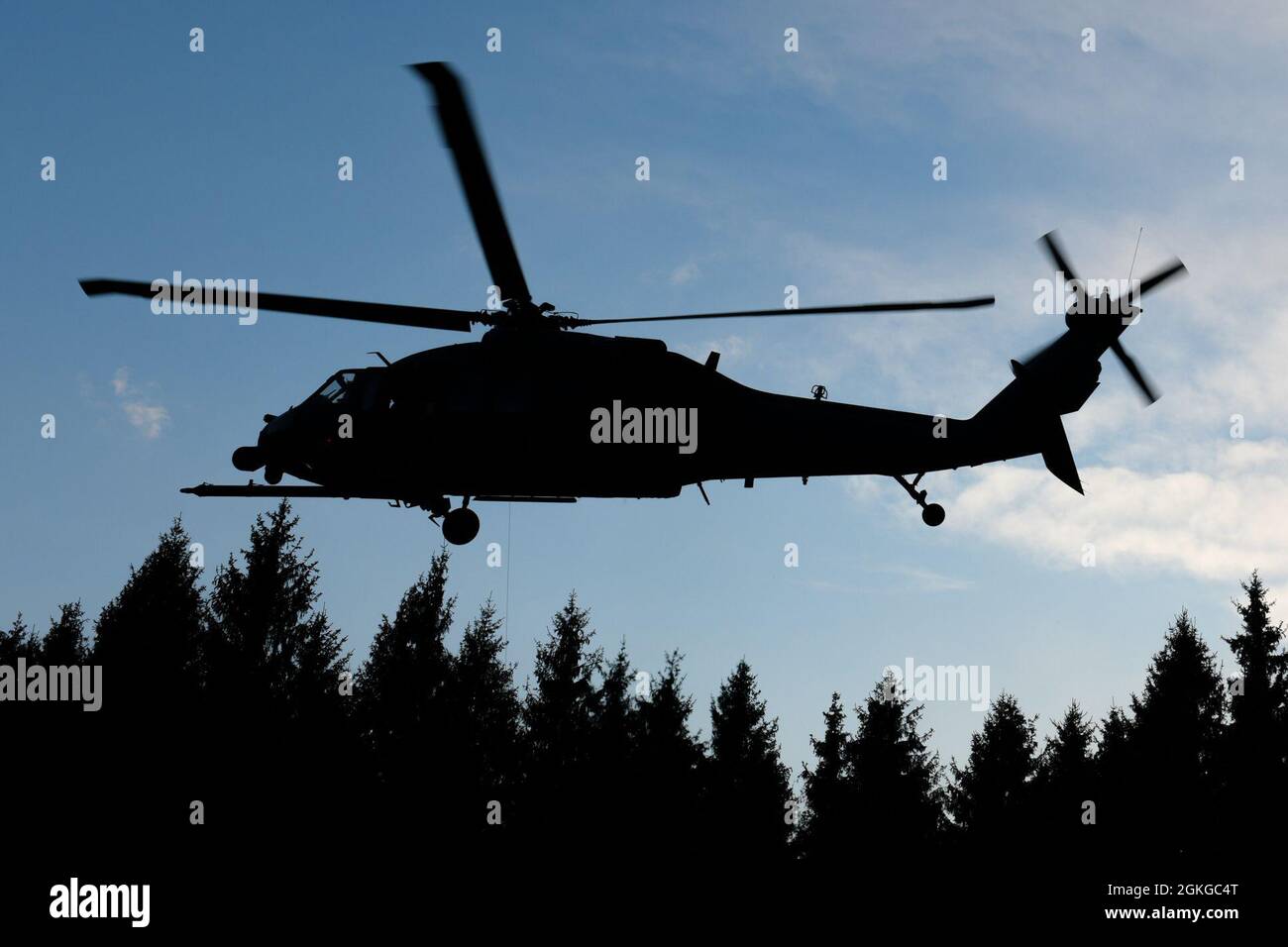 An HH-60 Pave Hawk prepares to rescue personnel at Cansiglio, Italy, April 15, 2021. The HH-60 rescued four ‘downed pilots’ in enemy territory during a combat survival training scenario. Stock Photo