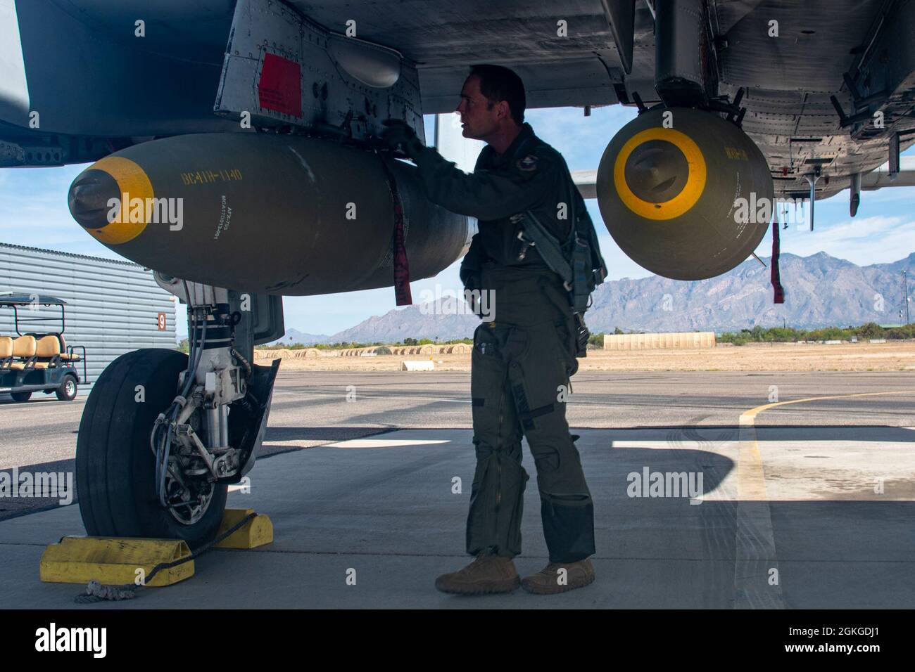 A U.S. Air Force A-10 Thunderbolt II pilot from the 40th Flight Test Squadron conducts pre-flight inspections at Davis-Monthan Air Force Base, Arizona, April 15, 2021. The 40th FTS trained new capabilities using four 2000lb bombs attached to the aircraft. Stock Photo