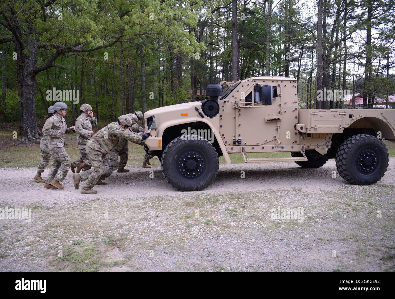 Soldiers from Support Battalion, 1st Special Warfare Training Group (Airborne) push a truck as part of a stress-shoot during the battalion's Commander's Cup competition at Fort Bragg, North Carolina April 15, 2021. The Soldiers from each company competed in a ruck march, obstacle course, land navigation, Jeopardy-themed trivia contest and stress shoot with pistols and rifles. Stock Photo