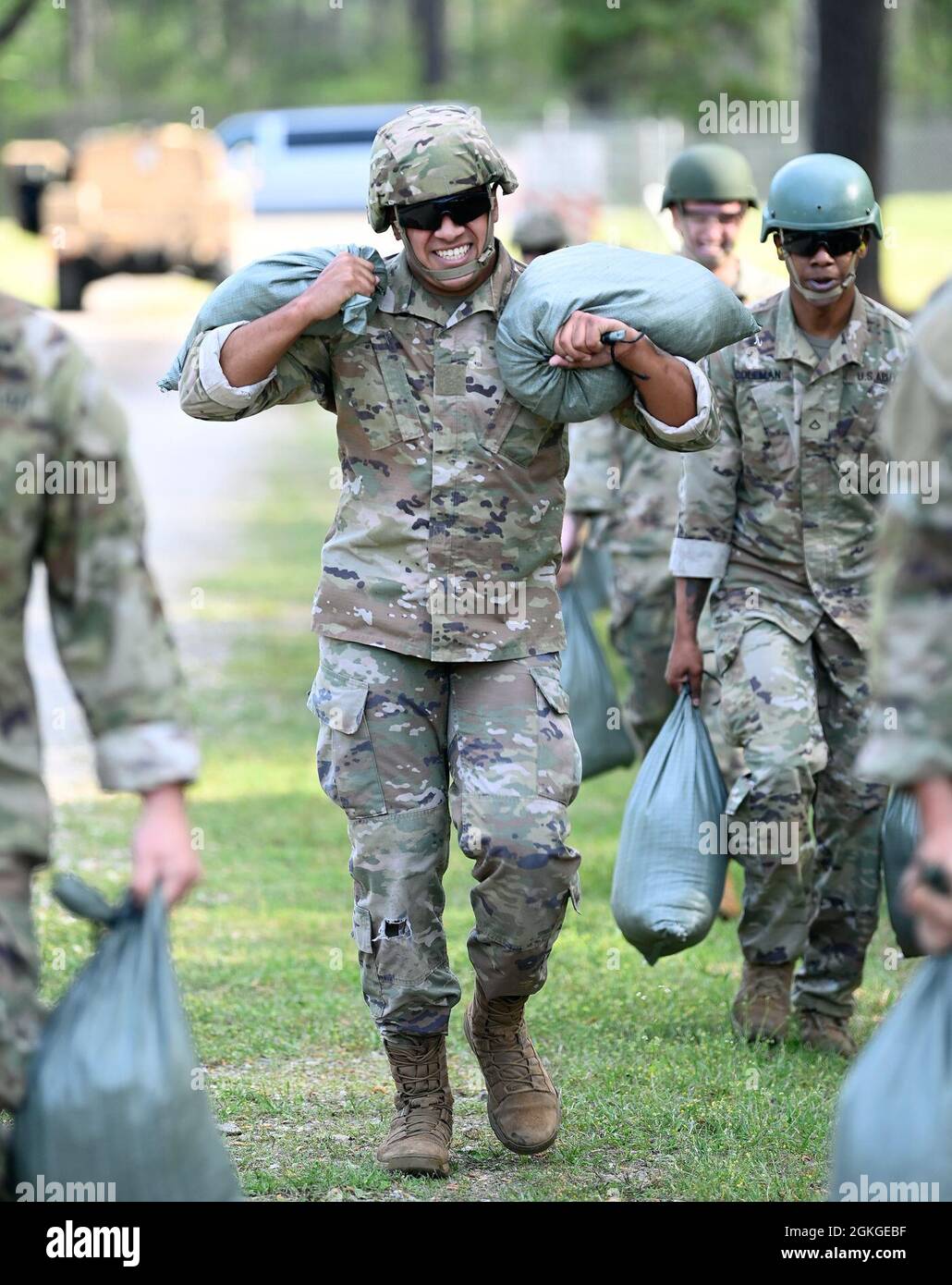 Soldiers from Support Battalion, 1st Special Warfare Training Group (Airborne) carry sandbags as part of a stress-shoot during the battalion's Commander's Cup competition at Fort Bragg, North Carolina April 15, 2021. The Soldiers from each company competed in a ruck march, obstacle course, land navigation, Jeopardy-themed trivia contest and stress shoot with pistols and rifles. Stock Photo