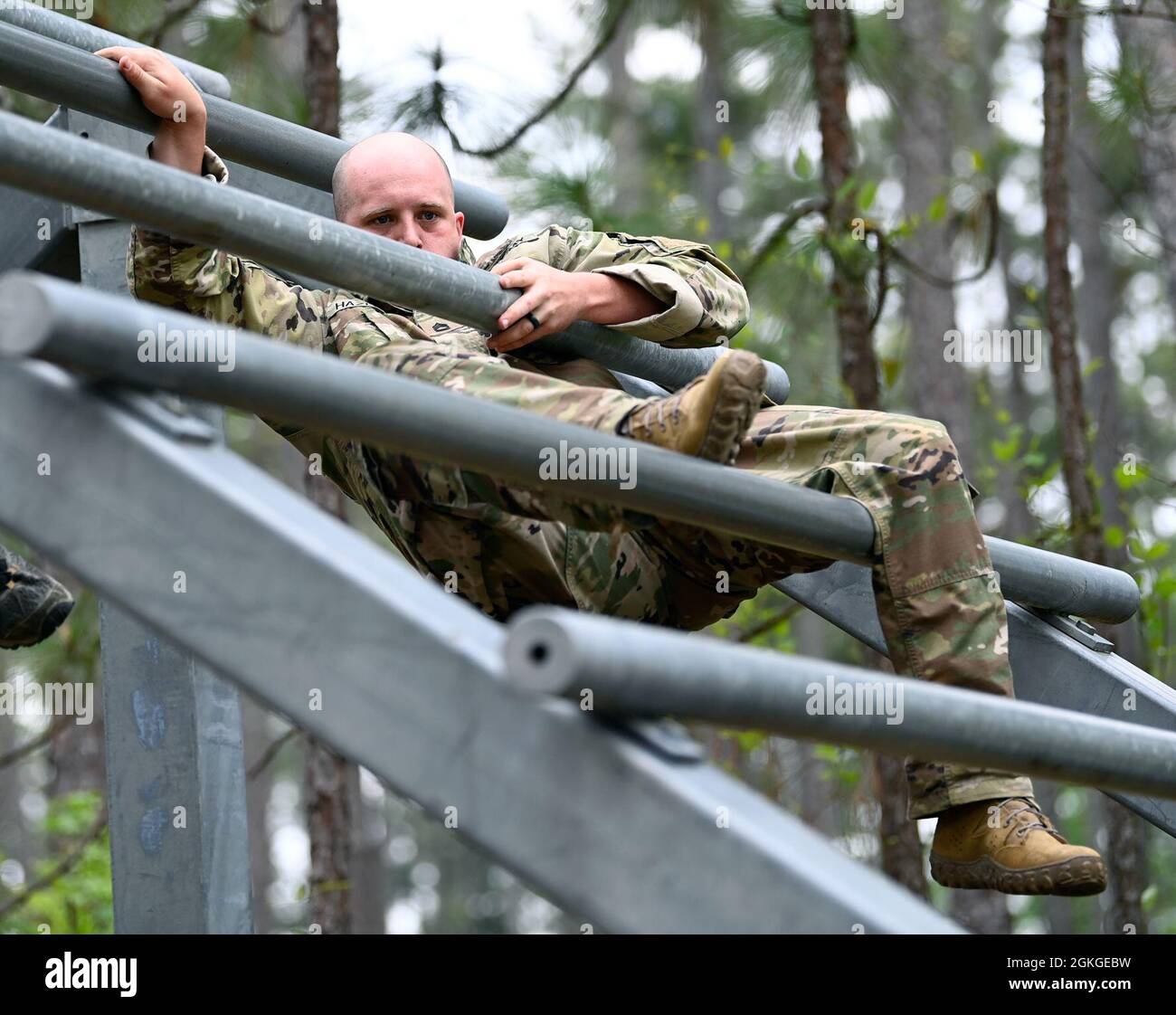 A Soldier from Support Battalion, 1st Special Warfare Training Group (Airborne) negotiates an obstacle during the battalion's Commander's Cup competition at Fort Bragg, North Carolina April 15, 2021. The Soldiers from each company competed in a ruck march, obstacle course, land navigation, Jeopardy-themed trivia contest and stress shoot with pistols and rifles. Stock Photo